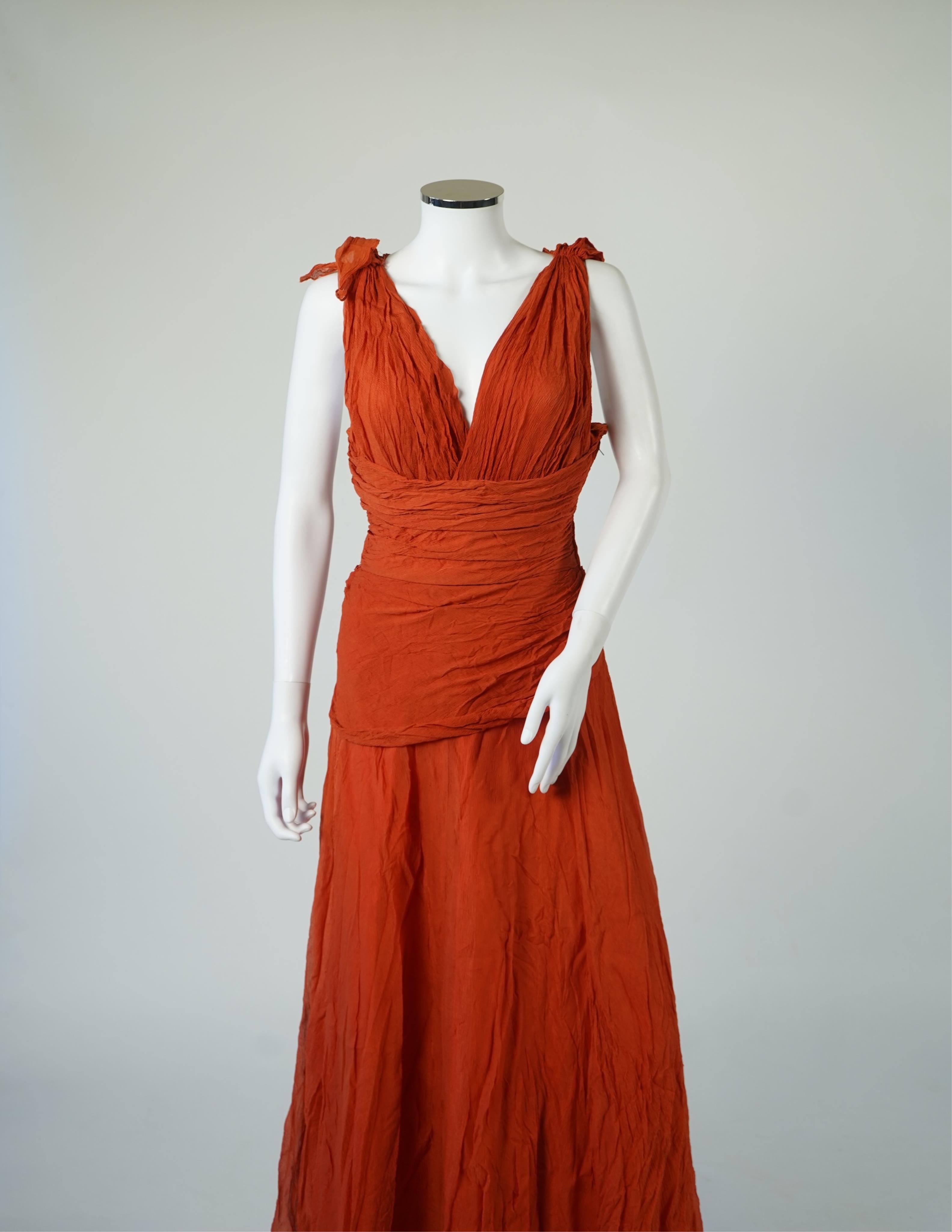 A 1940’s orange chiffon evening dress, with an orange silk taffeta lining, a pleated bodice and front apron panel tied at the back., 156 cm long. Condition - there are a few small holes in the chiffon at the back of the